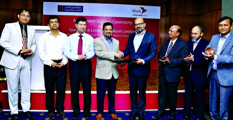 Md. Obayed Ullah Al Masud, Managing Director of Sonali Bank Limited and Kamal Quadir, CEO of bKash Limited, exchanging an agreement signing documents at a city hotel on Sunday. Under the deal, bKash customers will be able to pay the e-challan fees from th