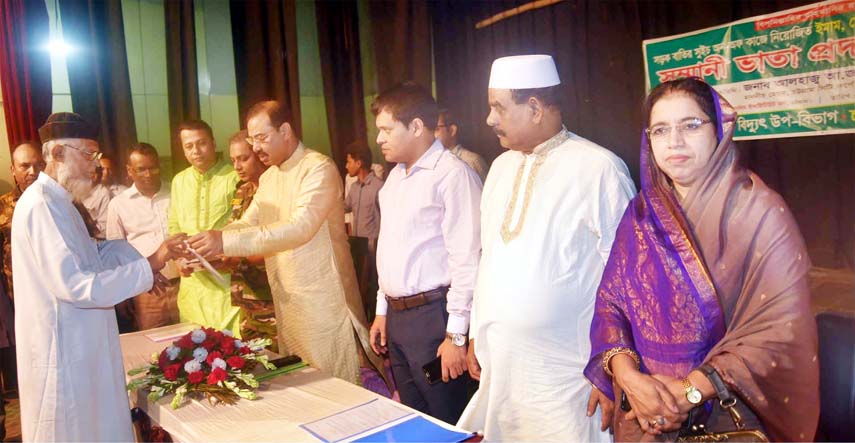 CCC Mayor A J M Nasir Uddin giving honorarium among the staff Roads lights on- off works at a function in the Port City on Tuesday.