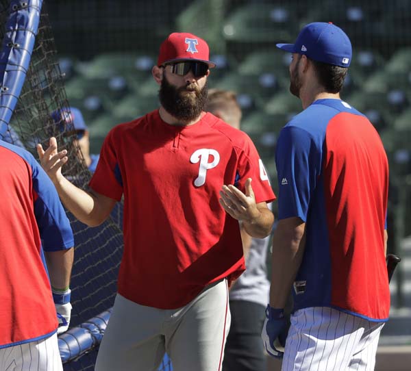 Philadelphia Phillies' Jake Arrieta (left) talks with former teammate Chicago Cubs' Kris Bryant during the Cubs' batting practice before a baseball game in Chicago on Tuesday.
