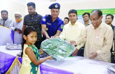 BHALUKA (Mymensingh): Prof Dr M Amanullah MP distributing educational materials among the children of minority at Bhaluka Upazila on Tuesday. Among others, Masud Kamal, UNO and Firoz Talukder, OC, Bhaluka Model were present in the programme.