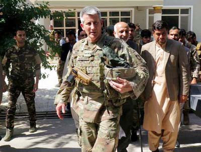 US Army General John Nicholson, Commander of Resolute Support forces and US forces in Afghanistan, walks with Afghan officials during an official visit in Farah province.