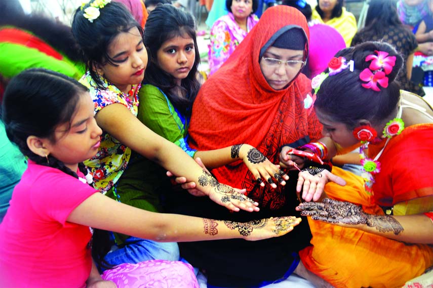 Jatiya Press Club family members decorated their arms with mehedi at a mehedi festival organised by the club on its auditorium on Friday on the occasion of holy Eid-ul-Fitr.