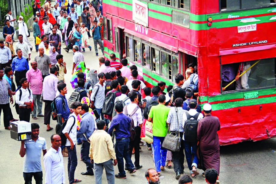 Passengers facing acute problems to reach their destinations due to shortage of transports and also traffic congestion at the market areas in the city ahead of Eid-ul-Fitr. The snap was taken from Farmgate area on Saturday.