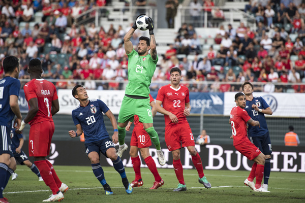 Switzerland's Keeper Roman Buercki, centre, in action against Japan's Tomoaki Makino, centre left, during an international friendly soccer match between Switzerland and Japan at the Cornaredo stadium in Lugano, Switzerland on Friday.