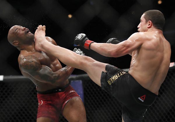 Robert Whittaker (right) kicks Yoel Romero in the face during their middleweight title mixed martial art bout at UFC 225, early on Sunday in Chicago.