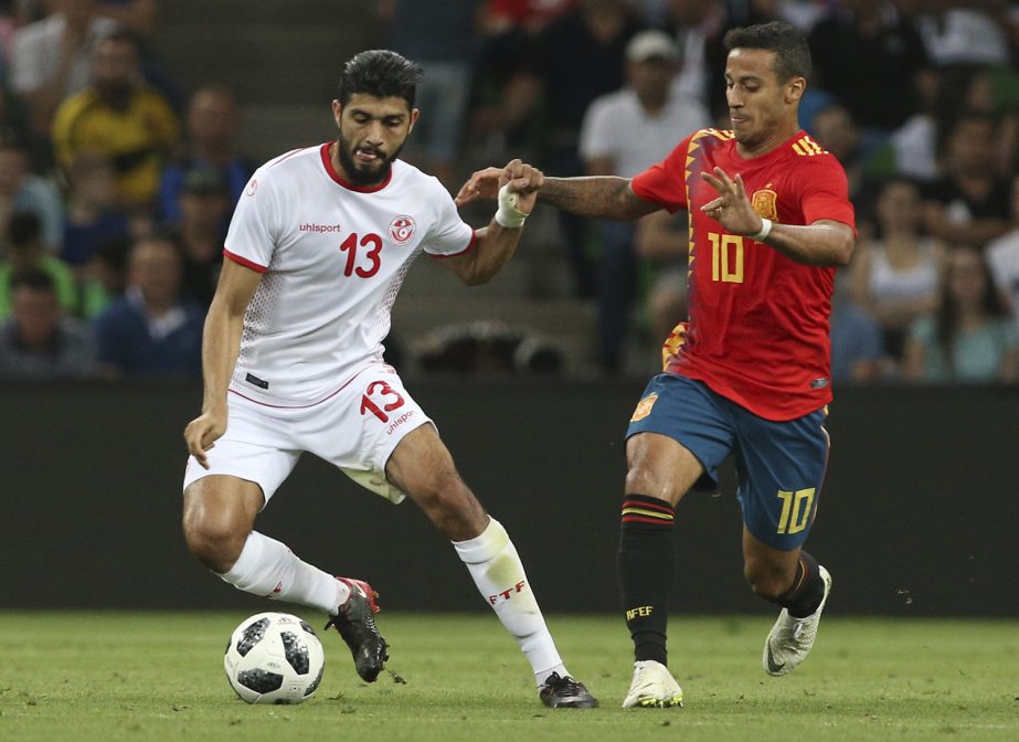 Spain's Thiago (right) struggles for the ball with Tunisia's Ferjani Sassi during a friendly soccer match between Spain and Tunisia in Krasnodar, Russia on Saturday.