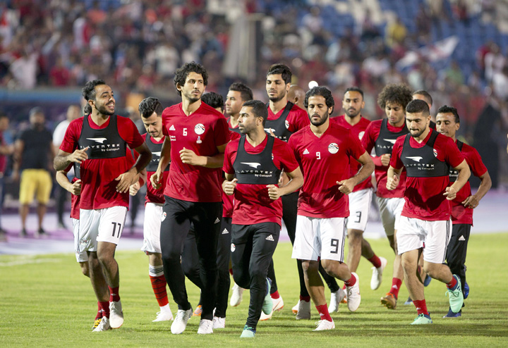Egyptian national team soccer players warm up, during the final training of the national team at Cairo Stadium in Cairo, Egypt on Saturday. About 2,000 fans gathered at Cairo's main stadium on Saturday to watch Egypt's last home practice before the Phar