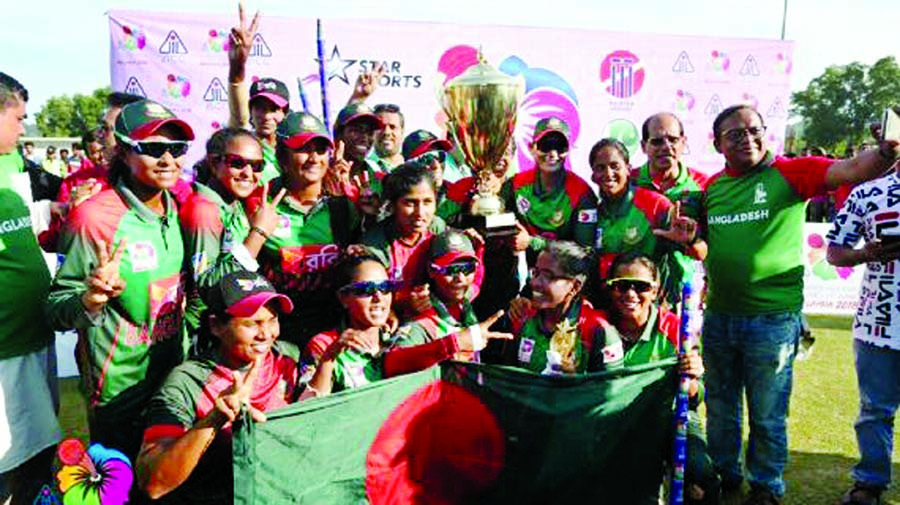Members of Bangladesh Women Cricket team with Asia Cup T-20 at Kinrara Academy Oval in Kuala Lumpur on Sunday. Tigresses won their maiden Asia Cup title defeating India by 3 wickets. (News on Page 7).
