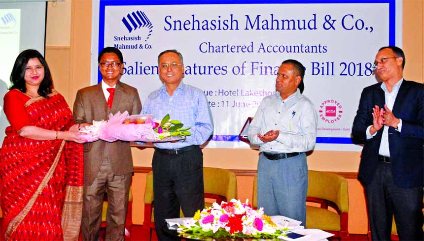 Zareen Mahmud Hosein, CPA, FCA, founder partner of Snehasish Mahmud & Co., receiving the guests of a discussion programme on Finance Bill 2018 at a hotel in the city Monday.