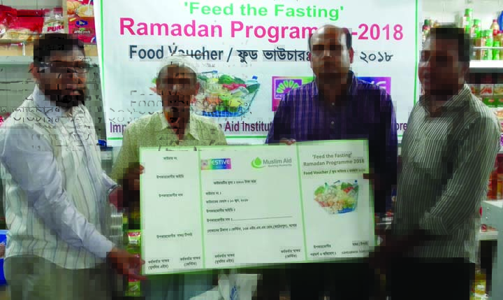 JASHORE: Md Arif-uz- Zaman, UNO, Jashore Sadar distributing food voucher organised by Muslim Aid under Ramzan programme recently.