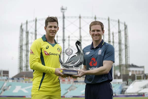 Australia captain Tim Paine (left) and England captain Eoin Morgan pose for photographers with the series trophy at the Oval cricket ground in London on Tuesday. England play Australia in a One-Day International cricket match on Wednesday.