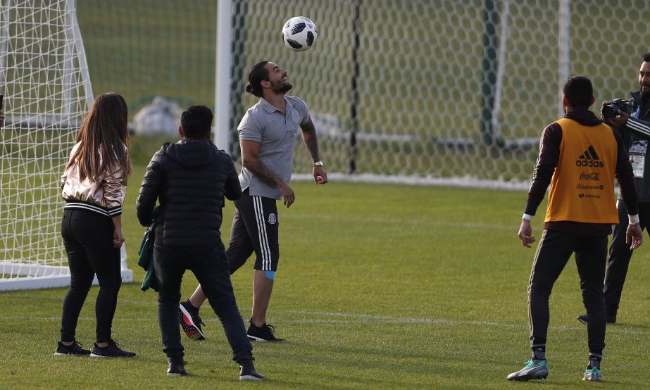 Colombian singer Maluma (left) control the ball next to Mexico goalkeeper Jose de Jesus Corona (right) at the end of a training session of the Mexico national soccer team, for the 2018 soccer World Cup, in Moscow, Russia on Tuesday.