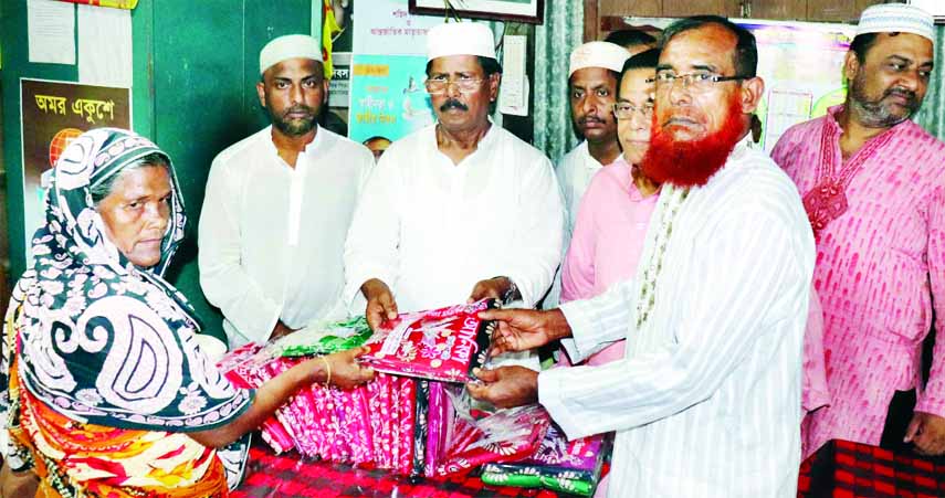 MURADNAGAR (Cumilla): Jahangir Alam Sarkar, General Secretary, Cumilla North Awami League distributing clothes among the Family members of freedom fighter and village police at Muradnagar Upazila Freedom Fighters' office yesterday.