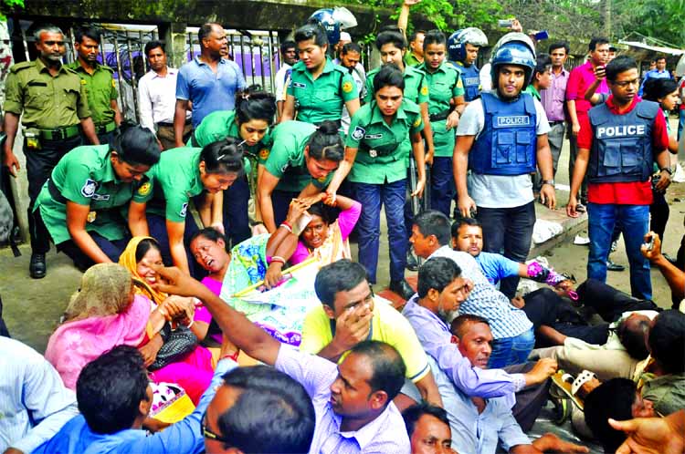 Members of law enforcing agencies evicting the teachers observing sit-in programme demanding inclusion in MPO list from in front of the Jatiya Press Club on Wednesday.