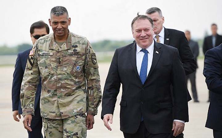US Secretary of State Mike Pompeo, right, walks with US General Vincent K. Brooks commander of United States Forces Korea, upon his arrival at Osan Air Base in Pyeongtaek on Tuesday.