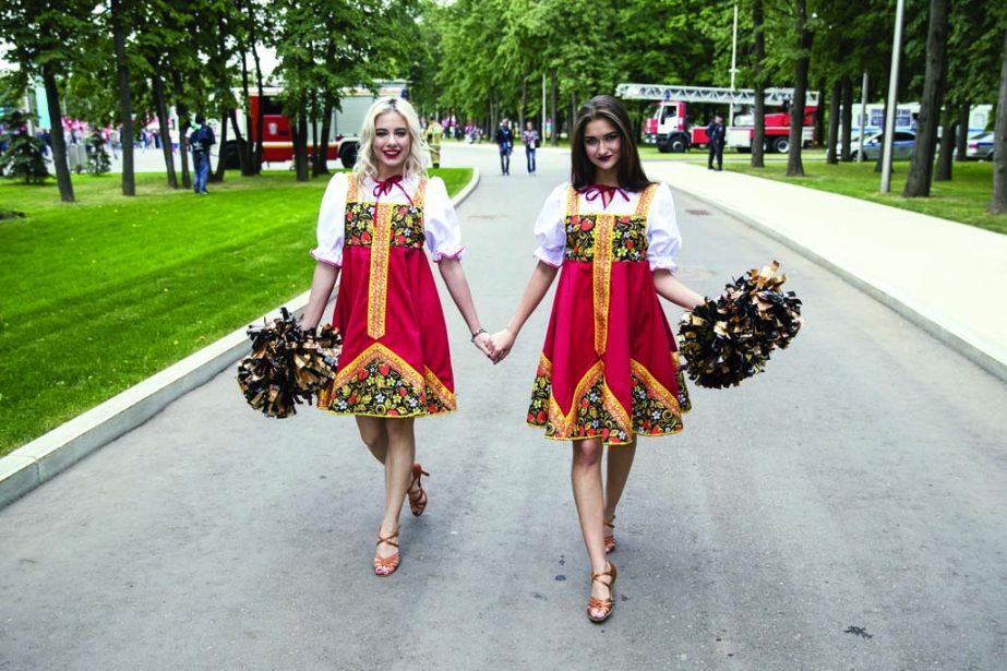 Two women dressed in Russian traditional costumes walk near the stadium before the group A match between Russia and Saudi Arabia which opens the 2018 soccer World Cup at the Luzhniki stadium in Moscow, Russia on Thursday.
