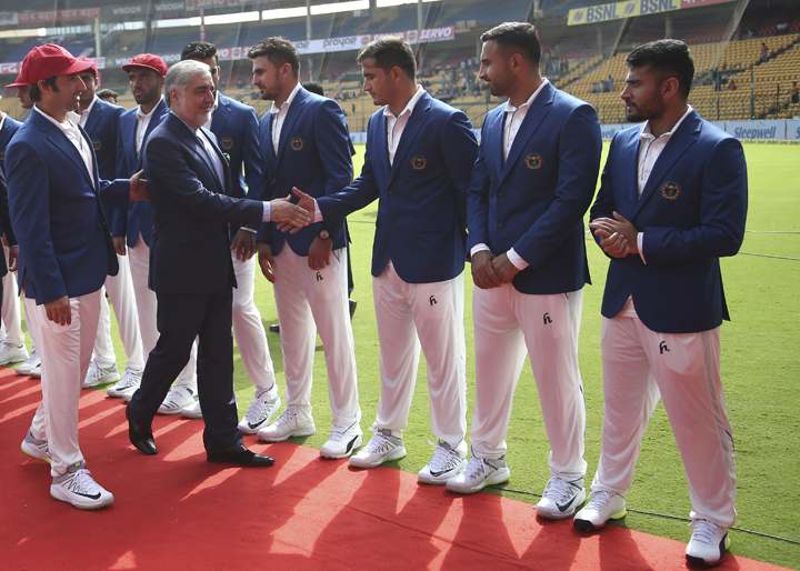 Afghanistan cricket team captain Asghar Stanikzai (left) introduces his team members to Afghanistan Chief Executive Abdullah Abdullah (second left) before the start of their one-off cricket test match against India in Bangalore, India on Thursday.