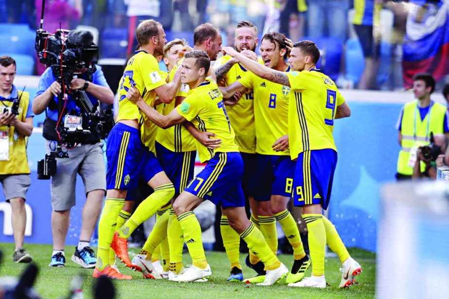 Sweden's Andreas Granqvist (center) celebrates with his teammates scoring his side's opening goal from the penalty spot during the group F match between Sweden and South Korea at the 2018 soccer World Cup in the Nizhny Novgorod stadium in Nizhny Novgoro