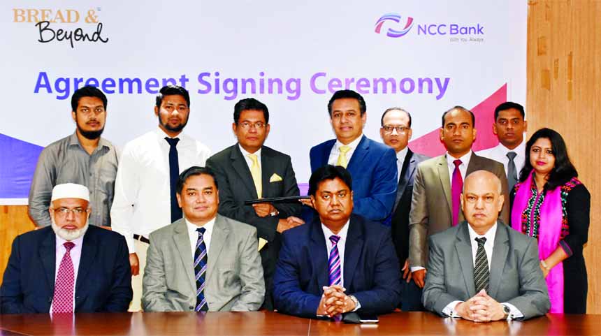 Muhammad H Kafi, Head of Cards of NCC Bank Ltd and Noor A Alam Chowdhury, Chairman of Bread & Beyond, exchanging the agreement documents at the bank head office recently. Mosleh Uddin Ahmed, Managing Director, Khondoker Nayeemul Kabir, Md. Habibur Rahman,