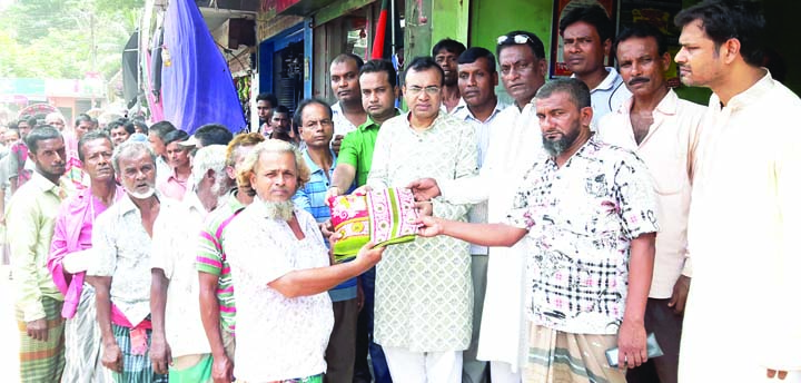 BANARIPARA(Barishal): Golum Faruk, Chairman, Banaripara Upazila distributing Eid clothes among the rickshaw, van and construction labourers recently.