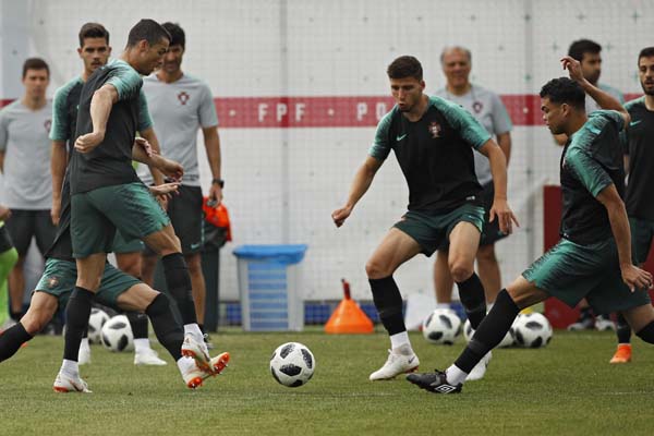 Portugal's Cristiano Ronaldo (left) plays the ball with teammates during Portugal's official training on the eve of the group B match between Portugal and Morocco at the 2018 soccer World Cup, in Kratovo, outskirts Moscow, Russia on Tuesday.
