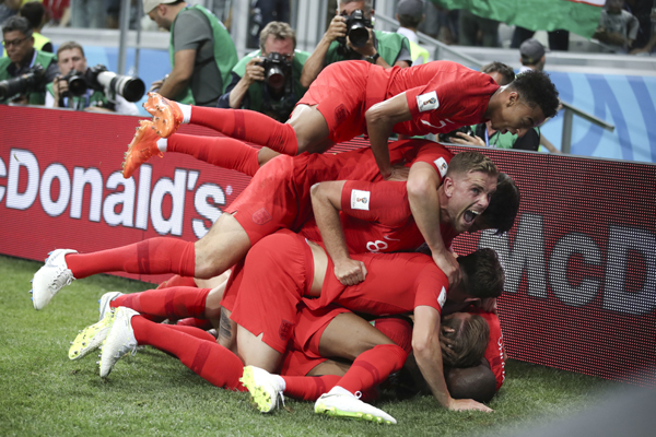 England's Harry Kane is cheered by teammates after scoring during the group G match between Tunisia and England at the 2018 soccer World Cup at the Volgograd Arena in Volgograd, Russia on Monday.