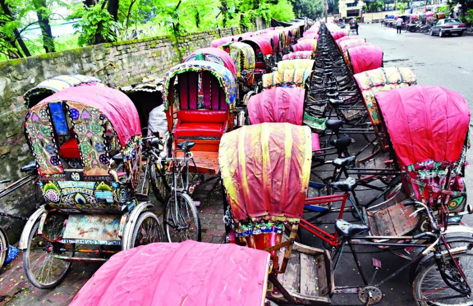 Rickshaws have been lined up in long queue in the streets as rickshawpullers left the city to celebrate Eid with near and dear ones in their village homes. This photo was taken from Tejgaon area on Tuesday.