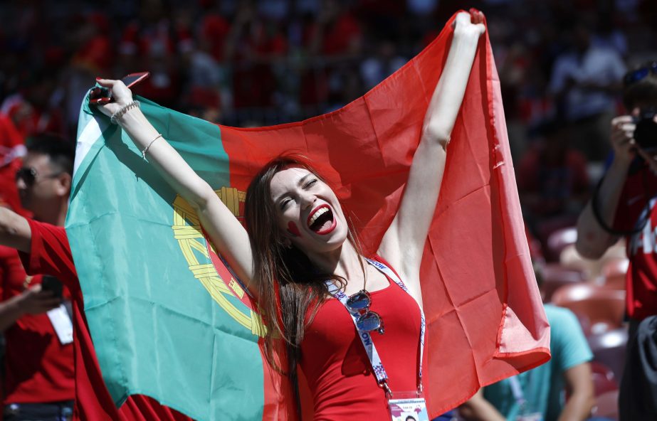 A woman holds a Portuguese flag prior to the group B match between Portugal and Morocco at the 2018 soccer World Cup at the Luzhniki Stadium in Moscow, Russia on Wednesday.