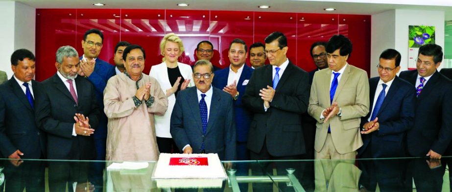 M Moniruzzaman Khandakar, Chairman of Midland Bank Limited, inaugurating its 5th anniversary programme by cutting a cake at its head office in the city on Wednesday. Md. Ahsan-uz Zaman, Managing Director, Kazi Zafarullah, Directors and top management of t