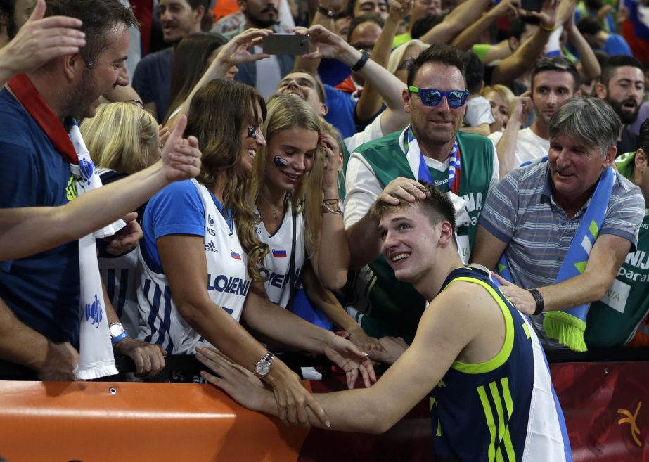 FILE - In this Sept. 14, 2017, file photo: Slovenia's Luka Doncic celebrates with the supporters at the end of their Eurobasket European Basketball Championship semifinal match against Spain, in Istanbul. Doncic is a possible pick in Thursday's NBA Draf
