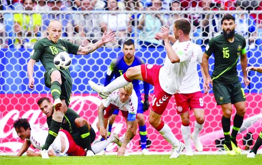 Australia's Aaron Mooy (left) clears a ball during the group C match between Denmark and Australia at the World Cup match in Samara, Russia on Thursday. Internet photo