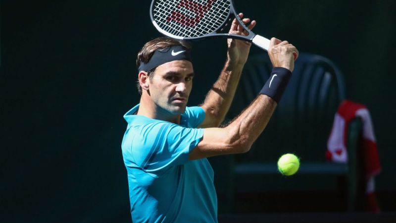 Switzerland Roger Federer returs a shot against France's Benoit Paire in their round of 16 match at the ATP tennis tournament in Halle, western Germany, Thursday.