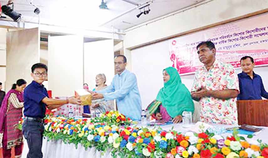 A teenagers' conference was held at the Small Ethnic Group Cultural Institute Auditorium in Rangamati town on Friday. The photo shows a teenage boy receiving a gift from DC AKM Mamunur Rashid.