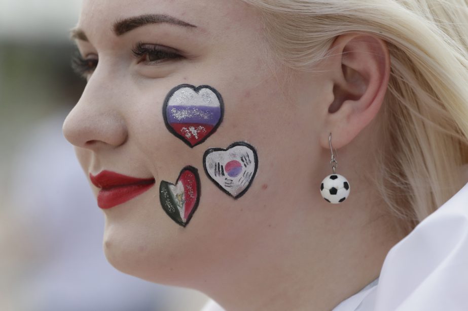 A Russian woman with her face painted with the Russia, Mexico and South Korea flags arrives outside of the Rostov Arena prior to the group F match between Mexico and South Korea at the 2018 soccer World Cup in Rostov-on-Don, Russia, Saturday