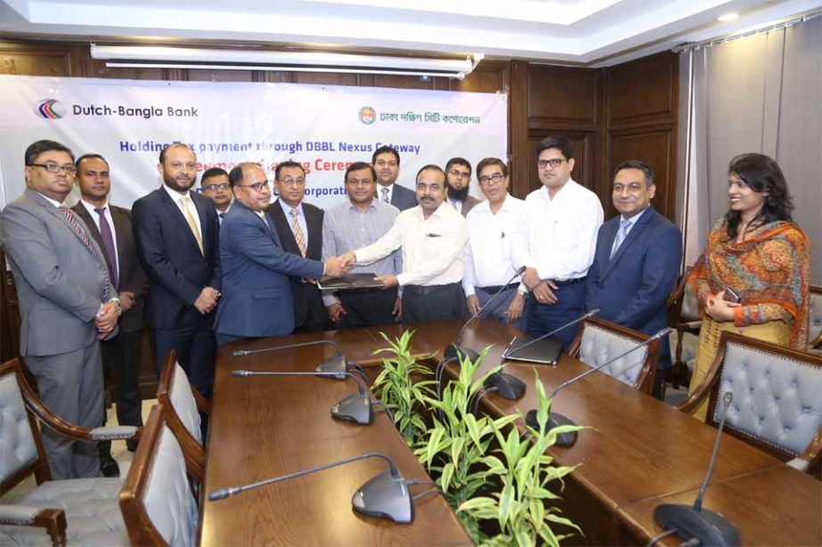 Khan Mohammad, CEO Dhaka South City Corporation (DSCC) and Md. Mosharraf Hossain, First Vice President of Dutch-Bangla Bank Limited, exchanging an agreement signing documents at DSCC office recently. Under the deal, dwellers of DSCC will be able to pay th