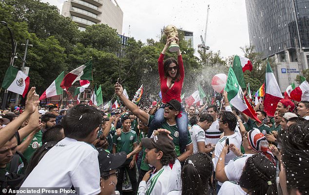Thousands of soccer fans and Gay Pride revelers converge on Mexico City's Angel of Independence on Reforma Avenue on Saturday. Soccer fans were celebrating Mexico's victory over Korea on Saturdayâ€™s World Cup soccer match as they met the massive G