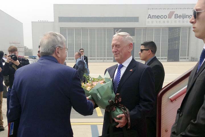US Defense Secretary Jim Mattis reciving a bouquet upon arrival at airport in Beijing on Tuesday.