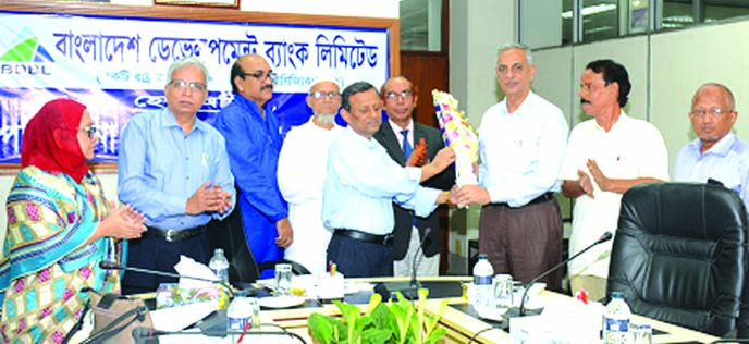 Manjur Ahmed, Managing Director of Bangladesh Development Bank Limited with other directors of the bank, greeting its newly appointed Director Kazi Tariqul Islam with a bouquet at the bank's head office in the city on Sunday. Shahabuddin Ahmed, Md Ekhlas