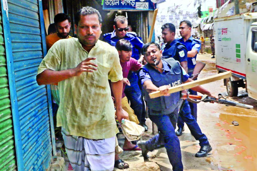 Police are seen dispersing the people gathered in front of Anannay Model School center area in Gazipur on Tuesday.