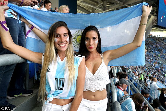 Two Argentina fans hold the national flag before the pivotal Group D clash.