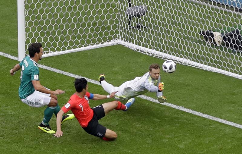 Germany goalkeeper Manuel Neuer dives for a save in front of South Korea's Son Heung-min (center) during the group F match between South Korea and Germany, at the 2018 soccer World Cup at the Kazan Arena in Kazan, Russia on Wednesday.