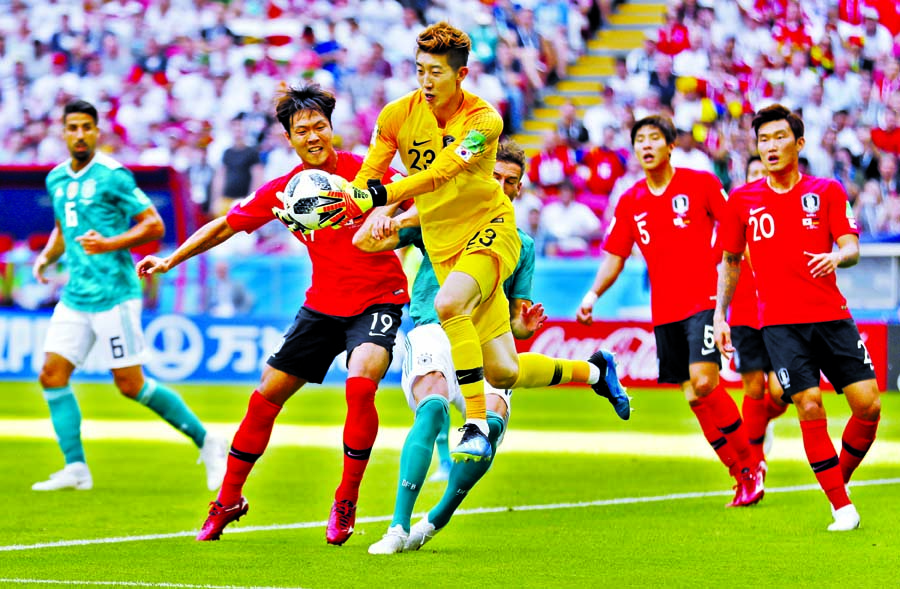 South Korea goalkeeper Jo Hyun-woo makes a save from a shot by Germany's Leon Goretzka, hidden behind, during the group F match between South Korea and Germany at the World Cup match in Kazan on Wednesday. First-half match remain goalless.