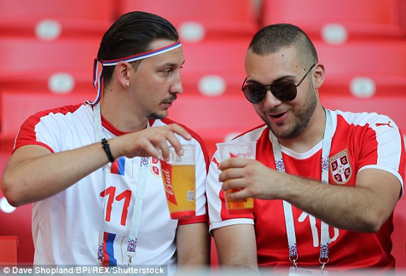Two Serbian fans enjoy a quick pint