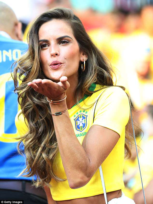 Izabel was photographed blowing a kiss as she enjoyed the game.