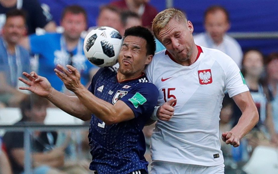 Shinji Okazaki (left) and Kamil Glik challenge for the ball during the World Cup Group H match between Japan and Poland at the Volgograd Arena in Russia on Thursday.