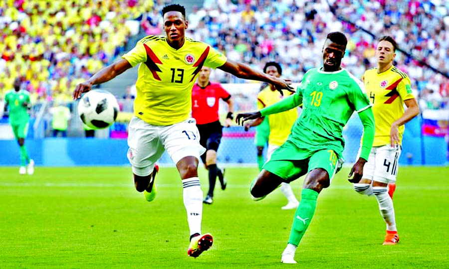 Colombia's Yerry Mina in action with Senegal's M'Baye Niang at half-time of their World Cup match on Thursday.