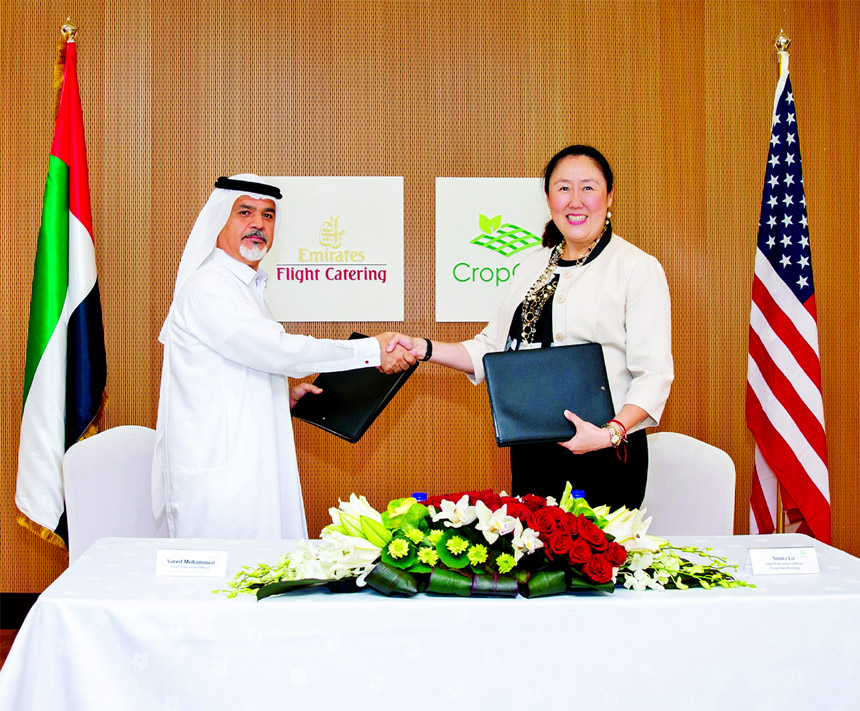 Saeed Mohammed, CEO of Emirates Flight Catering and Sonia Lo, CEO of Crop One Holdings, shaking hands after signing a joint venture project for building the world's largest vertical farming facility near Al Maktoum International Airport at Dubai recently
