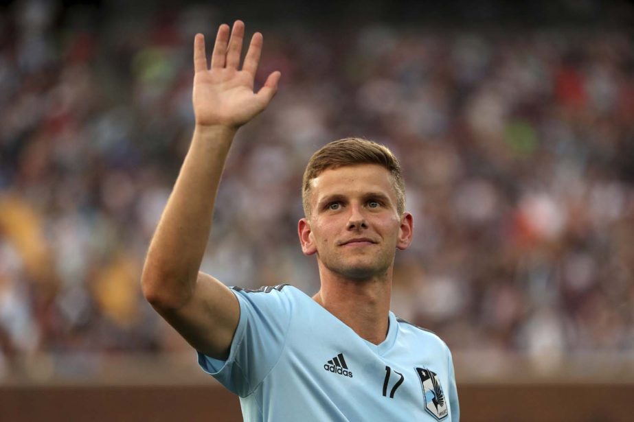 Minnesota United midfielder Collin Martin, who came out publicly as gay earlier in the day, waves to fans after taking part in a halftime presentation during the team's MLS soccer match against FC Dallas on Friday in Minneapolis.
