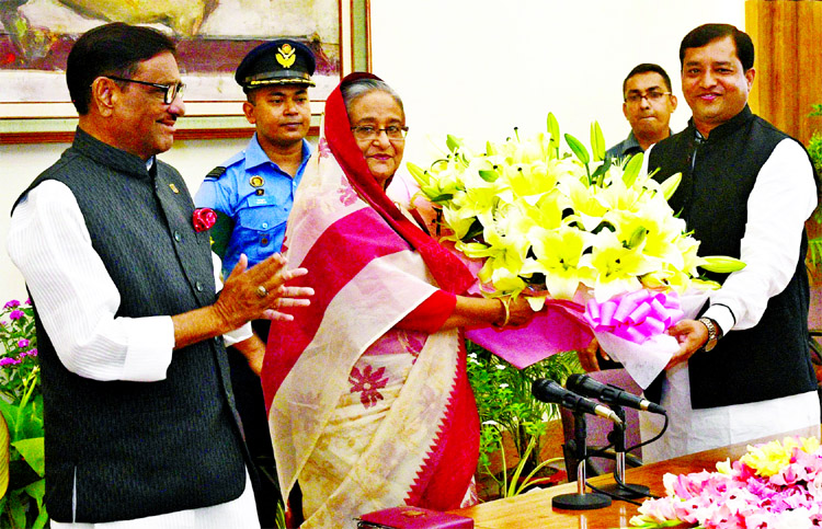 Newly elected Gazipur City Corporation Mayor Md Jahangir Alam handing over floral wreaths to Prime Minister Sheikh Hasina at the Ganabhaban on Saturday.