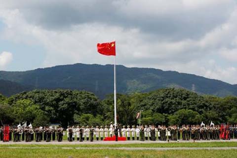 People's Liberation Army soldiers attend a flag raising ceremony at an airbase in Hong Kong a day before the 21st anniversary of the city's return to Chinese sovereignty from British rule.